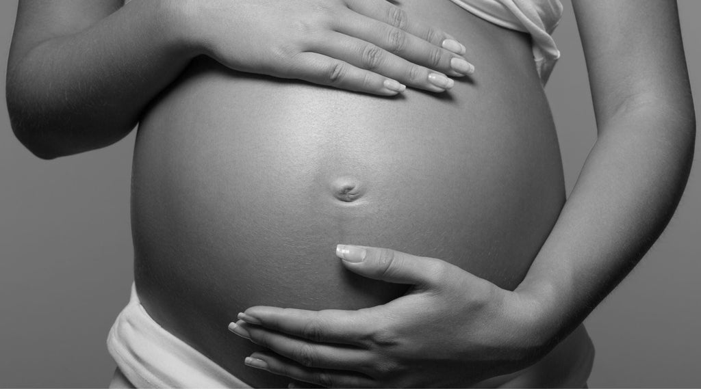 woman holding stomach during first 1000 days 